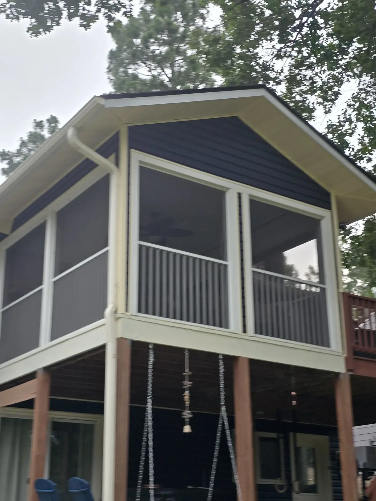White roofline gutters and downspout on screened porch from VTG’s project gallery