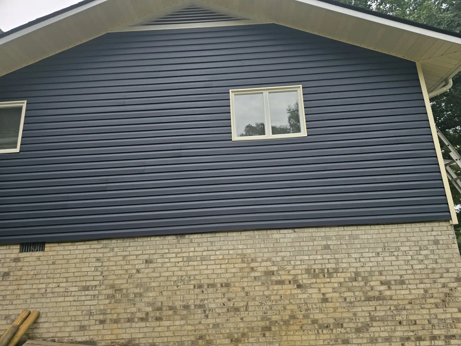 Gable vent, white soffit and navy siding from VTG’s website gallery