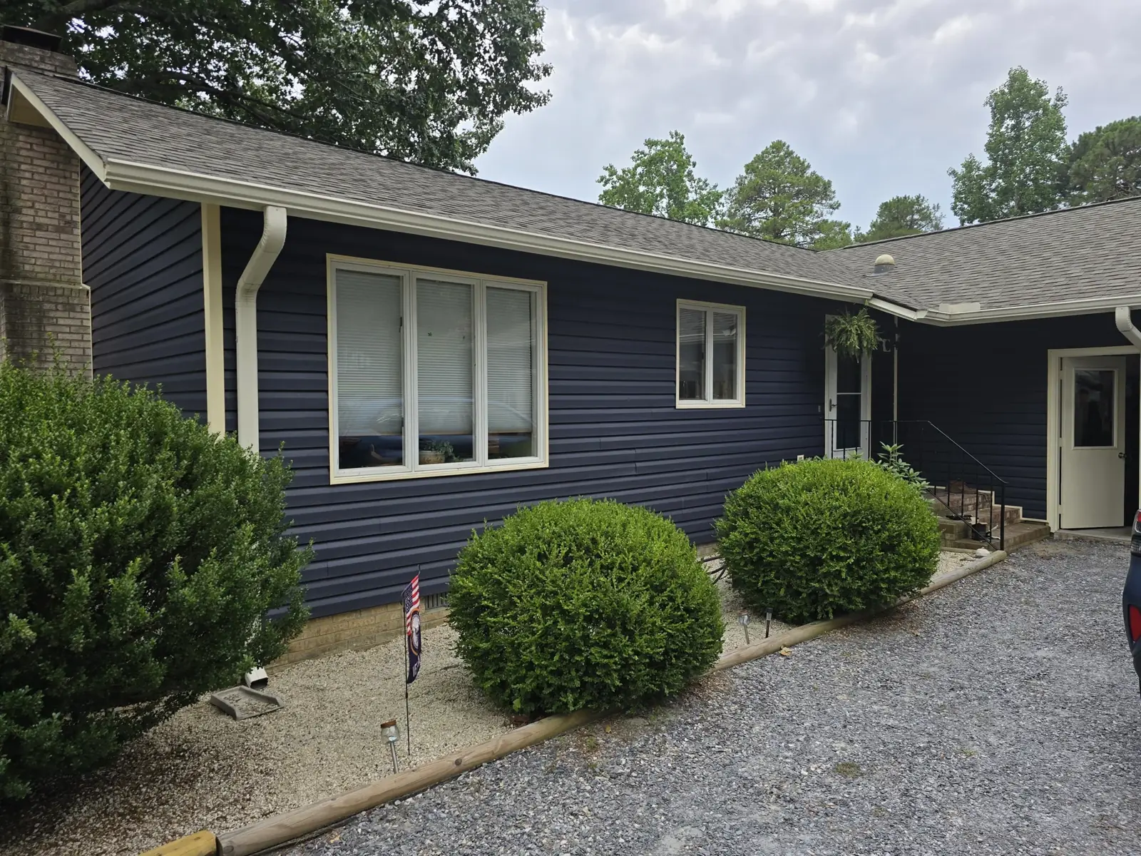 Roofline, gutters and navy siding from VTGroofing.com’s project gallery